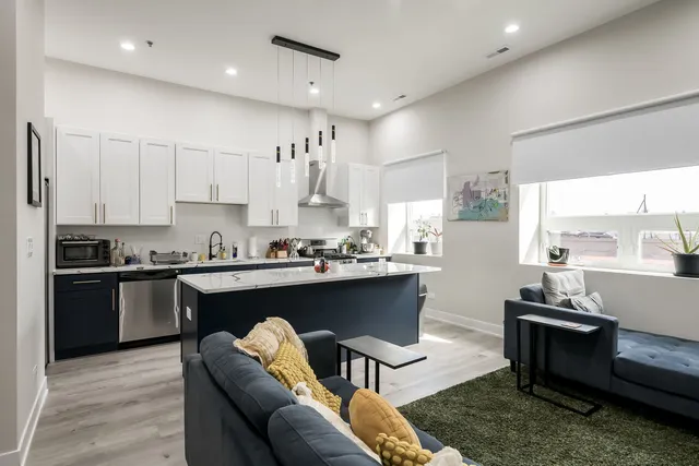 a kitchen with stainless steel appliances kitchen island granite countertop a sink and cabinets