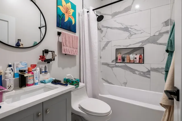 a bathroom with a sink a mirror and a toilet