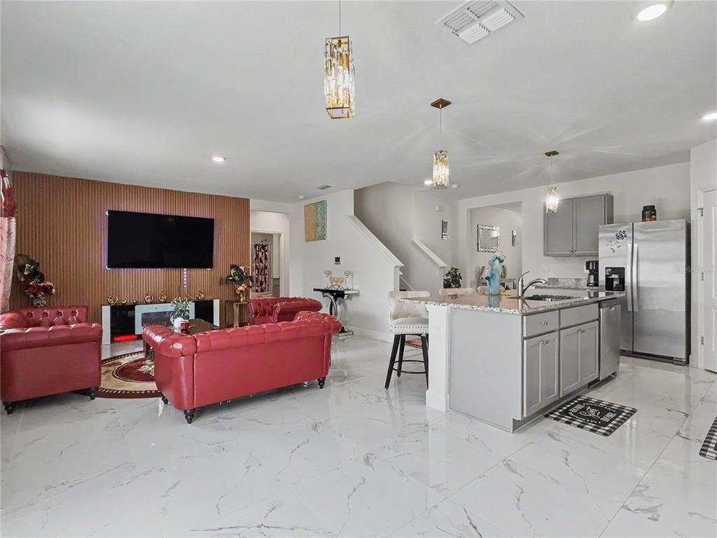 2085 Doe Run Drive Davenport, FL 33837 - Photo 20 of 44 a living room with furniture and a flat screen tv