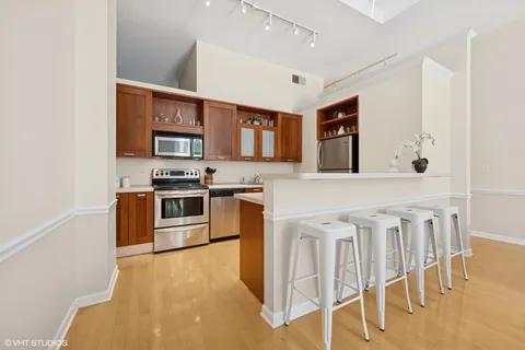 a kitchen with stainless steel appliances granite countertop a refrigerator stove and sink