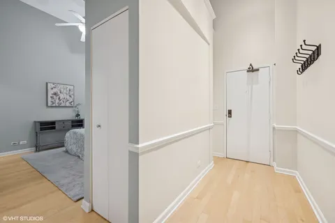 a view of an entryway with wooden floor and a livingroom view