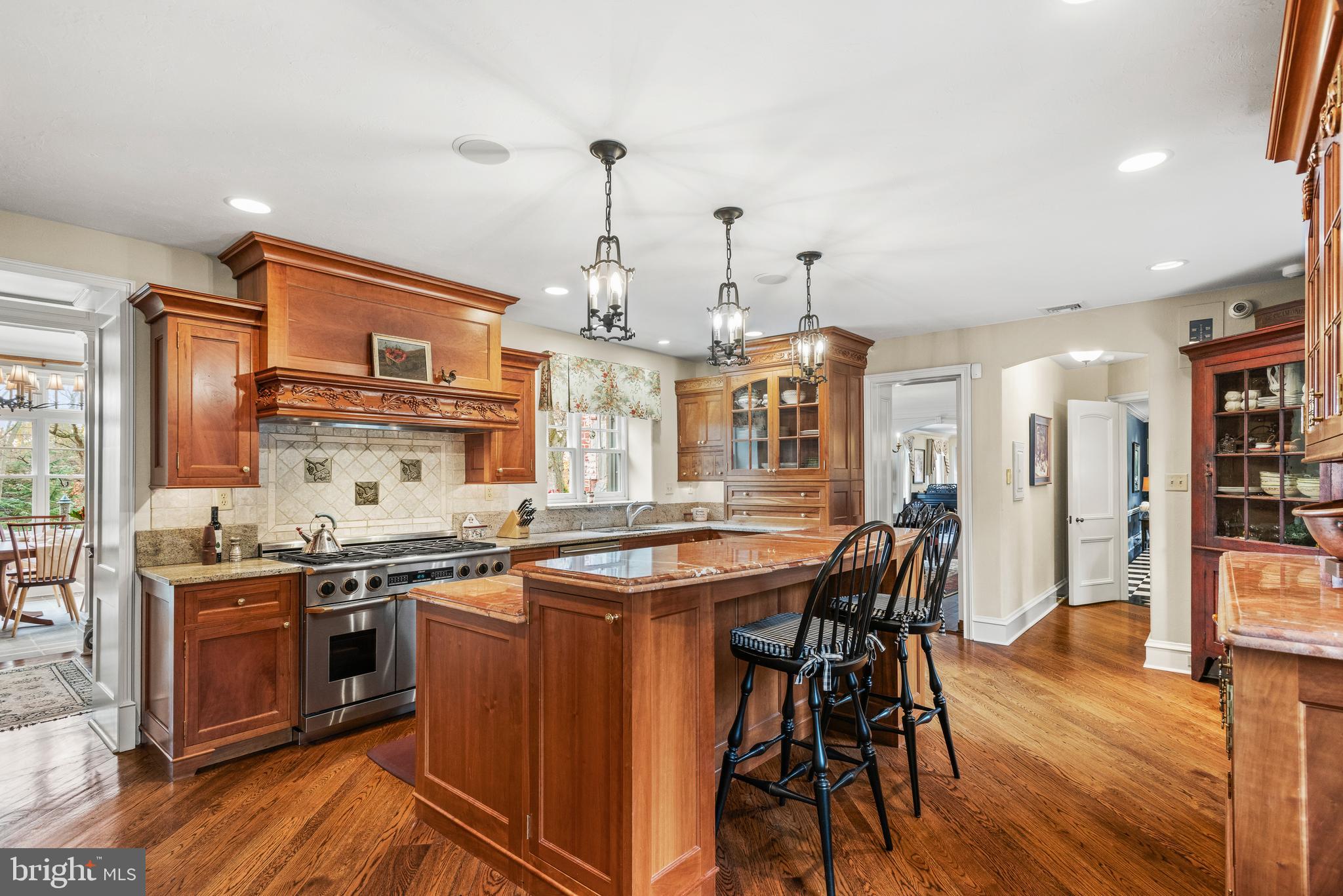 620 North Spring Mill Road Villanova, PA 19085 - Photo 35 of 118 a kitchen with stainless steel appliances granite countertop a stove and chairs