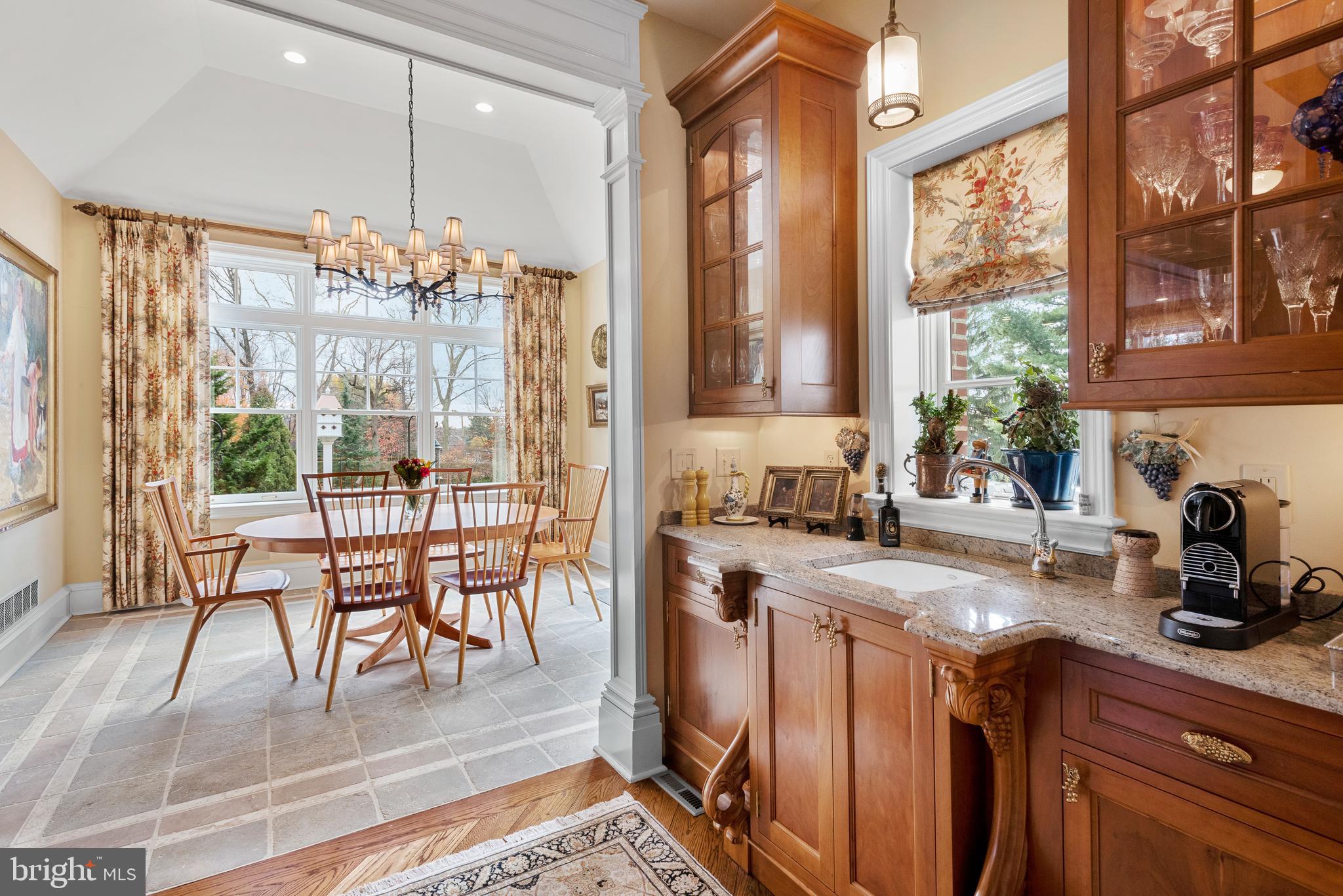 620 North Spring Mill Road Villanova, PA 19085 - Photo 36 of 118 a kitchen with stainless steel appliances granite countertop a stove a sink and a dining table with granite countertops