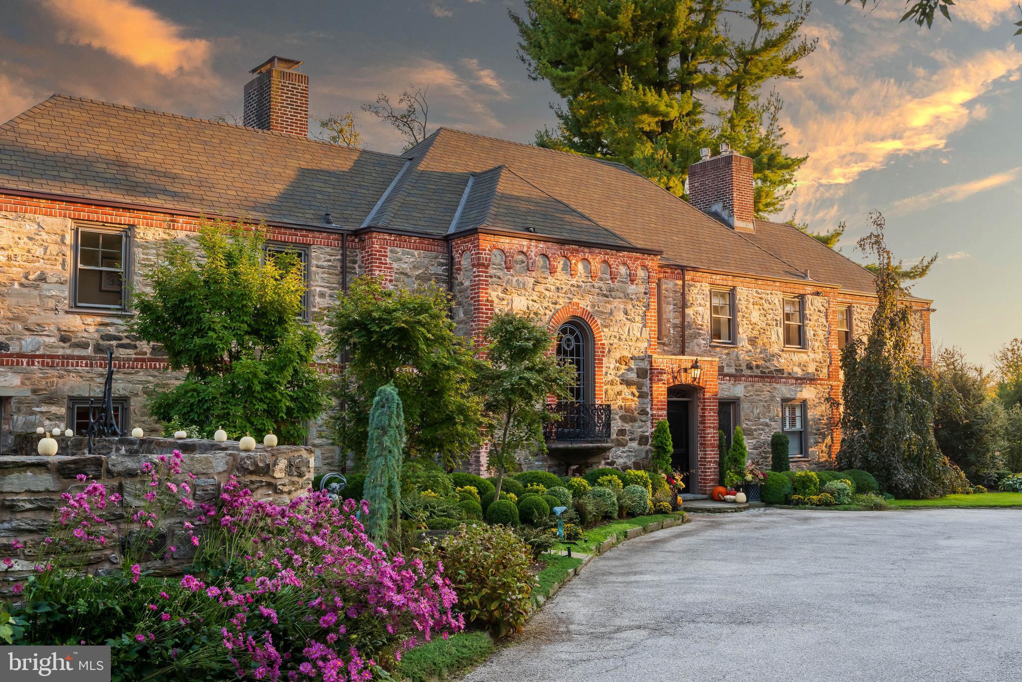 620 North Spring Mill Road Villanova, PA 19085 - Photo 71 of 118 a front view of a house with a yard and fountain in middle
