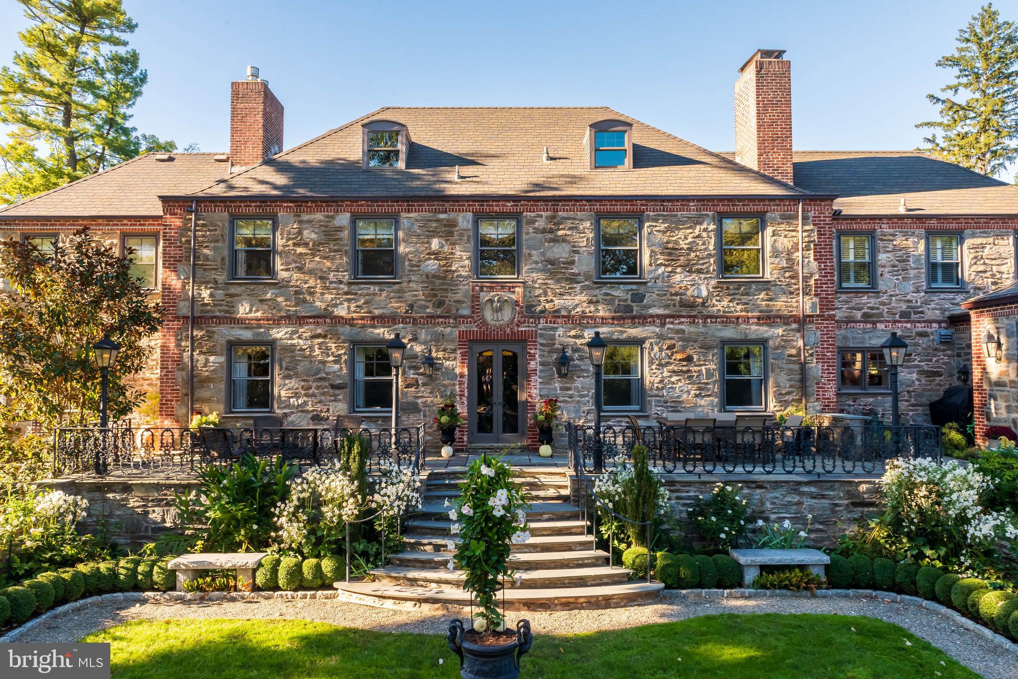 620 North Spring Mill Road Villanova, PA 19085 - Photo 81 of 118 a front view of a house with a garden and plants