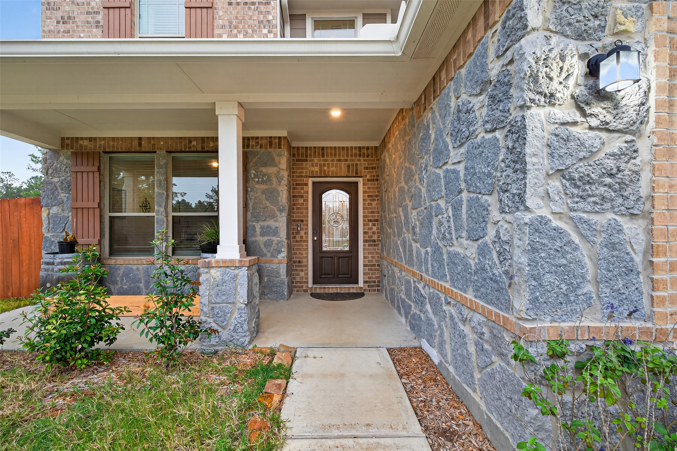 16601 Crosby Street Conroe, TX 77303 - Photo 5 of 50 Inviting front entry with a covered porch, stone accents, and a beautiful decorative front door welcoming you inside.