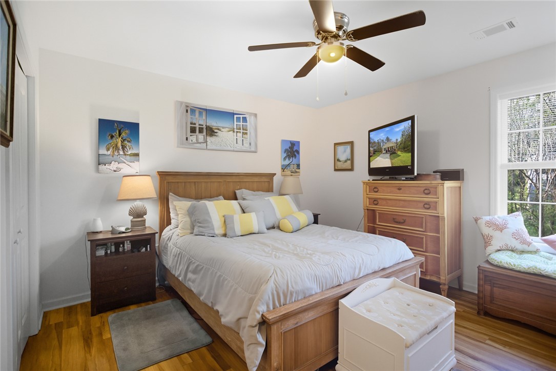 310 North Church Street Walhalla, SC 29691 - Photo 11 of 30 This airy primary bedroom offers a comfortable retreat with ample natural light.