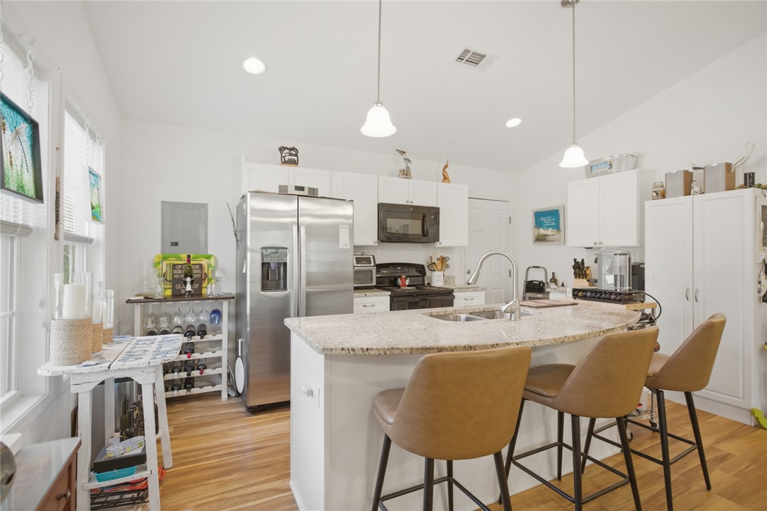 310 North Church Street Walhalla, SC 29691 - Photo 4 of 30 This bright kitchen features a functional island with a sink and modern appliances.