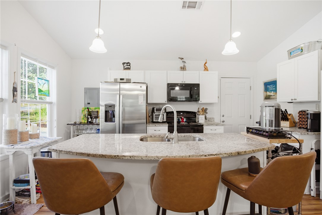 310 North Church Street Walhalla, SC 29691 - Photo 5 of 30 This bright kitchen features a spacious island with seating, ideal for casual dining and entertaining.