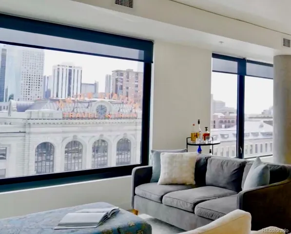 a living room with furniture and large window