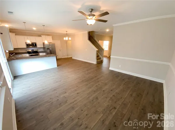 a view of kitchen with furniture and a ceiling fan