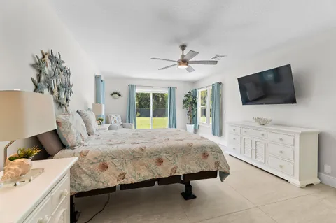 a bathroom with a tub a sink and a large mirror