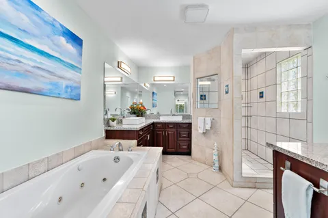 an empty room with windows and fireplace