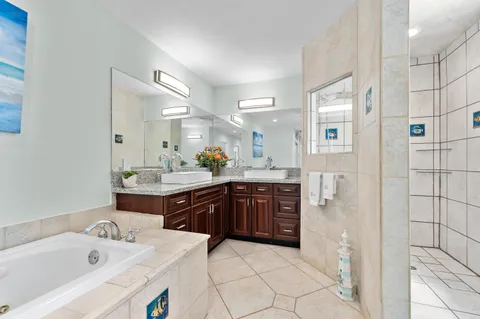 a kitchen that has a sink a stove and chairs