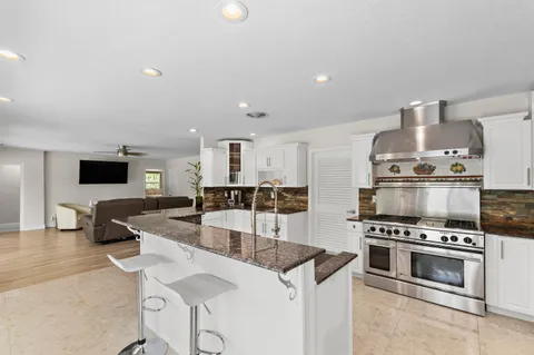 a kitchen with appliances a sink and cabinets