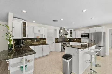 a view of a dining room with furniture and a floor to ceiling window