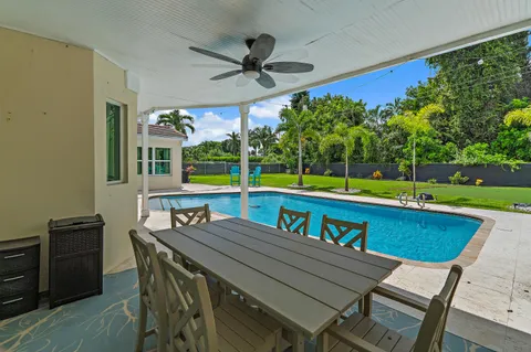 a room with furniture a flat screen tv and a window