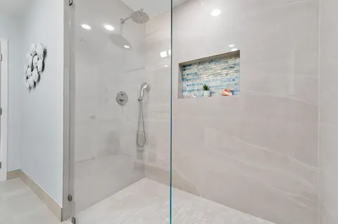 a bedroom with a large bed and a chandelier