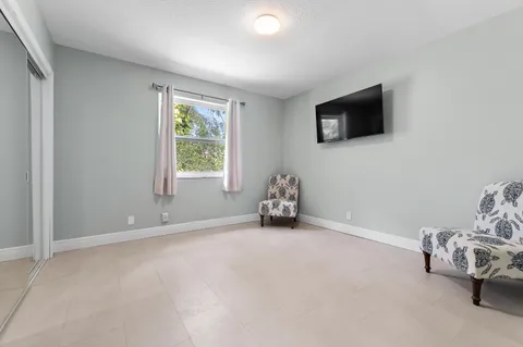 a view of a house with a big yard and sitting area