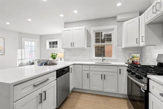 a kitchen with a sink stove and cabinets