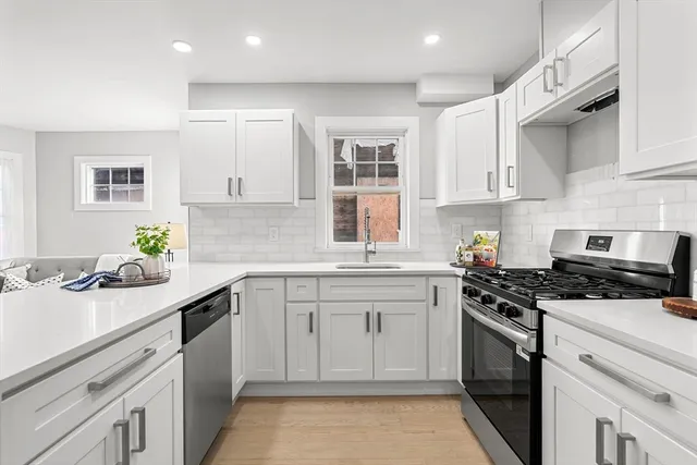 a kitchen with a sink stove and cabinets
