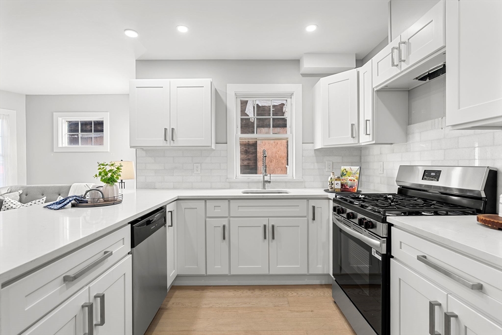 679-683 Columbia Road, Unit 1 Boston, MA 02125 - Photo 15 of 31 a kitchen with a sink stove and cabinets
