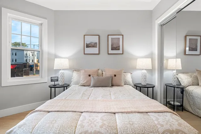 a bedroom with a large bed and a window