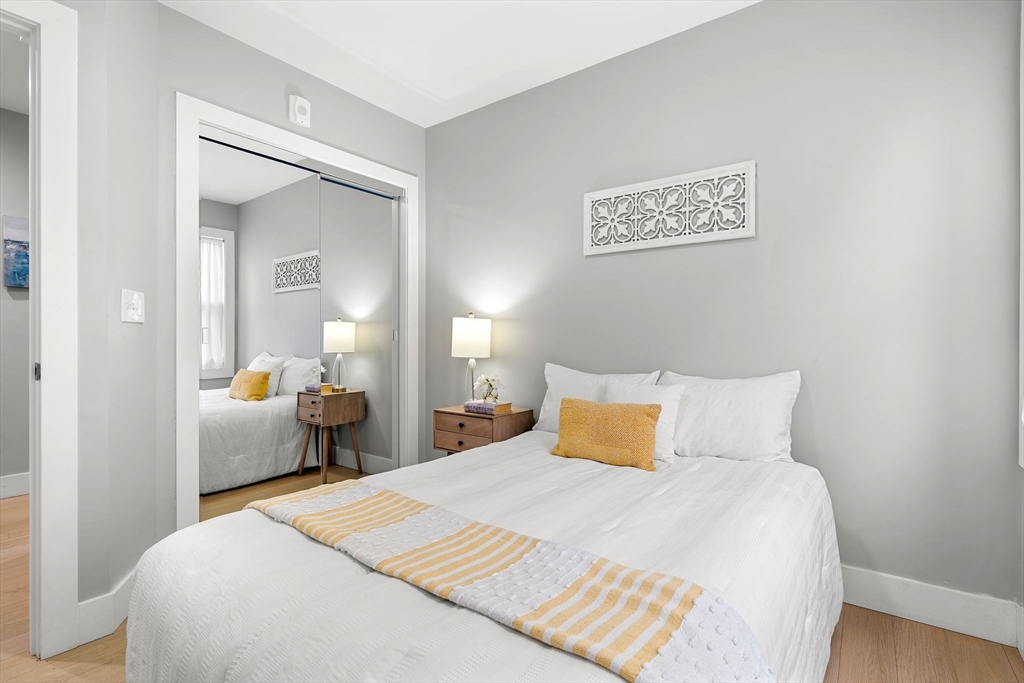 679-683 Columbia Road, Unit 1 Boston, MA 02125 - Photo 23 of 31 a bedroom with a bed and wooden floor