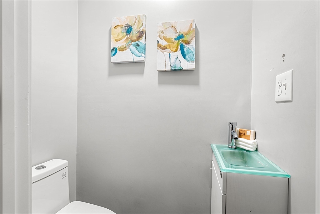 679-683 Columbia Road, Unit 1 Boston, MA 02125 - Photo 25 of 31 a bathroom with a toilet and a sink