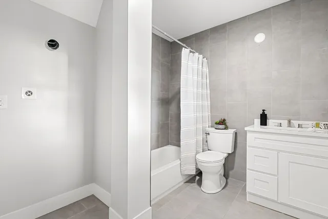 a bathroom with a toilet sink and a mirror