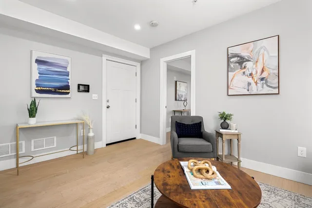 a living room with furniture and a potted plant