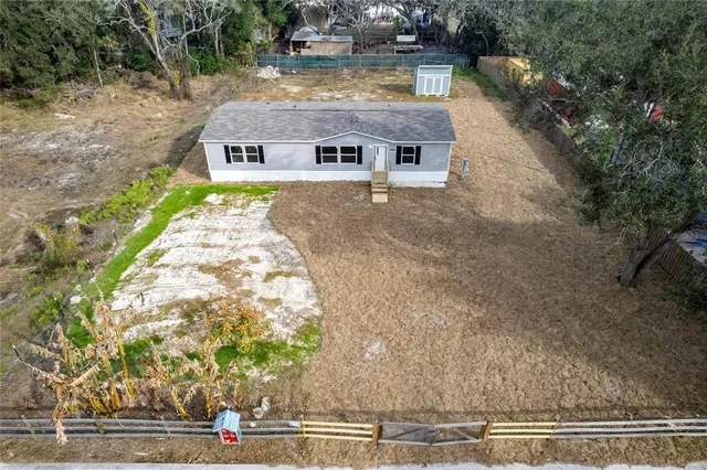 a aerial view of a house with a yard