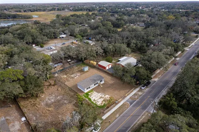 an aerial view of multiple houses with yard