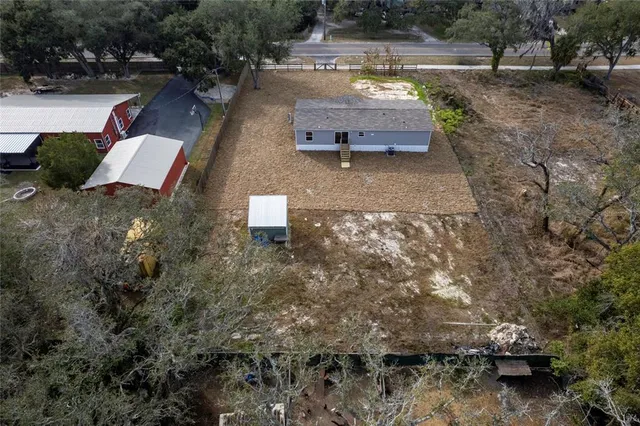 an aerial view of a house with outdoor space