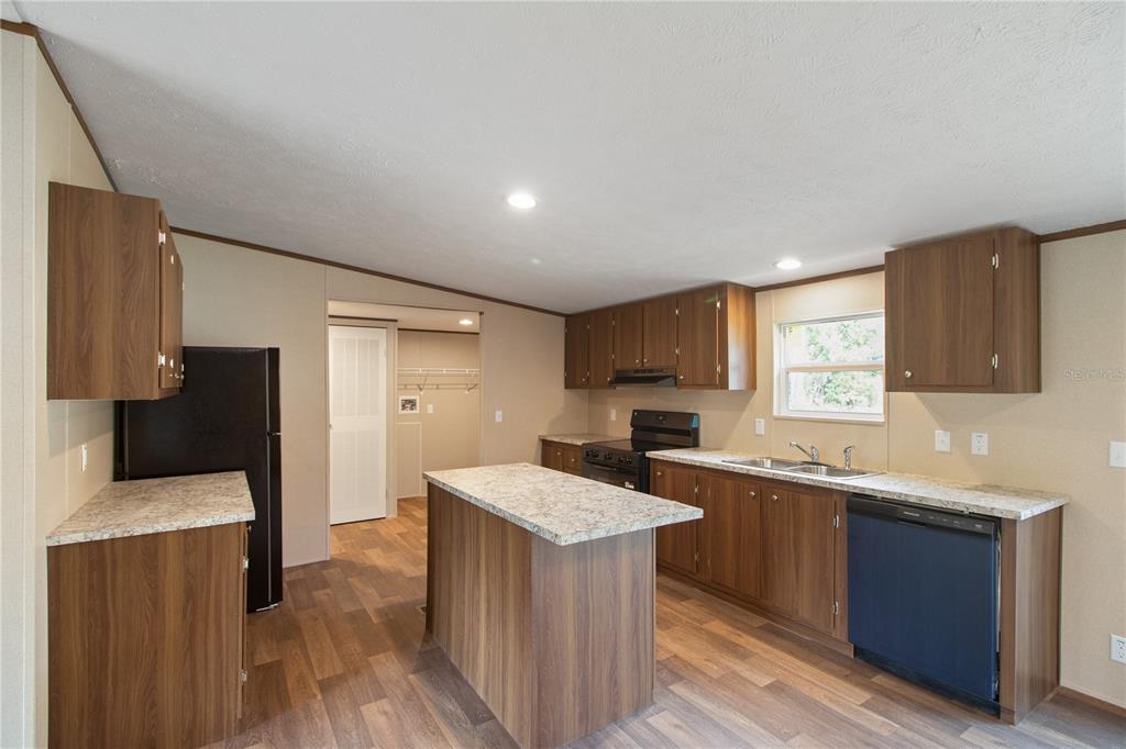 12396 Hicks Road Hudson, FL 34669 - Photo 19 of 33 a kitchen with a sink a counter top space and stainless steel appliances