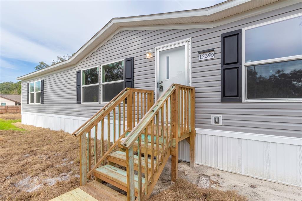 12396 Hicks Road Hudson, FL 34669 - Photo 8 of 33 a view of balcony with wooden floor and fence