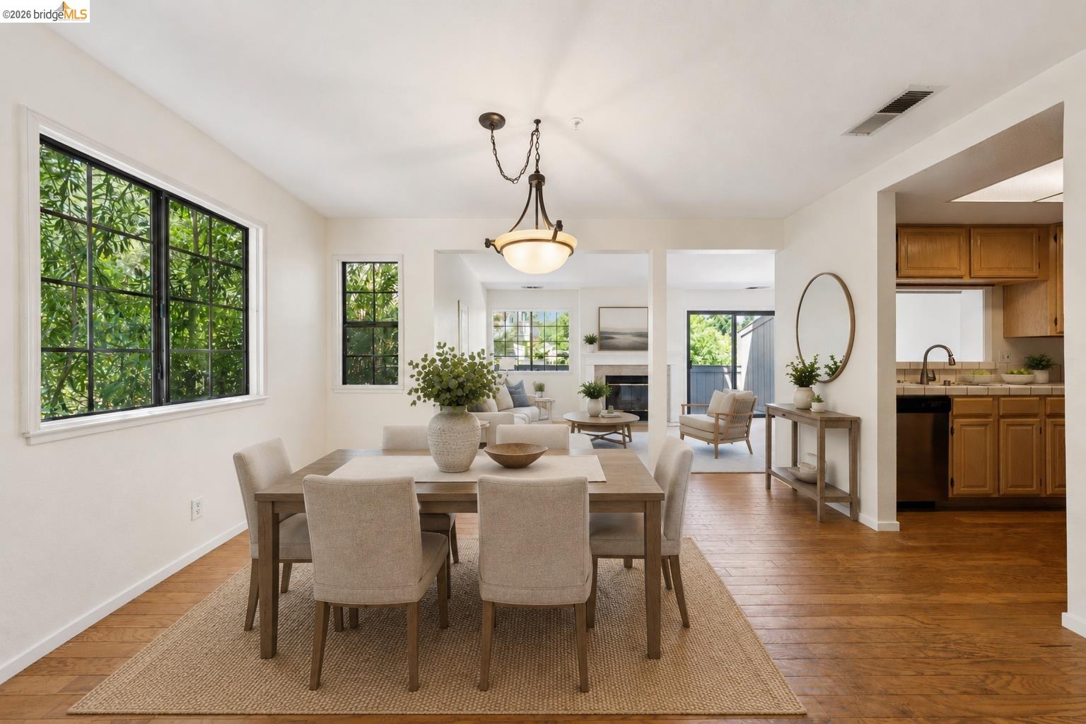 261 Redhawk Road Novato, CA 94949 - Photo 3 of 44 Dining area featuring wood-finish flooring, a contemporary chandelier, and grid-pattern windows