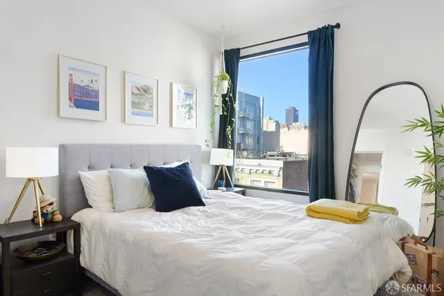 a bedroom with a bed and a painting on the wall