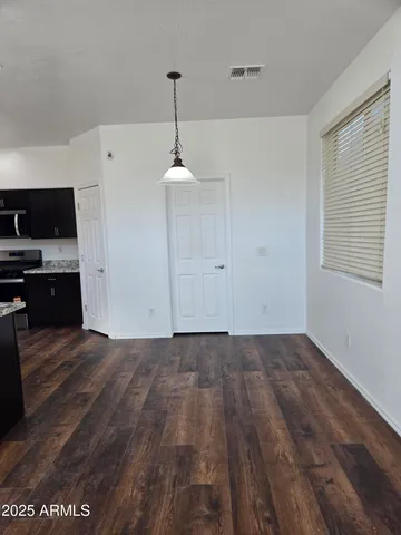 a view of walk in closet with empty racks