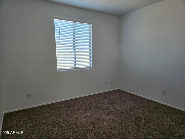 a view of an empty room and a window