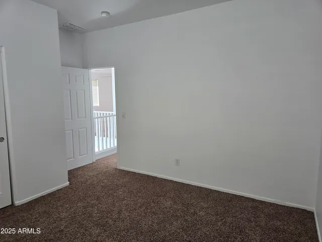 a view of an empty room and a window