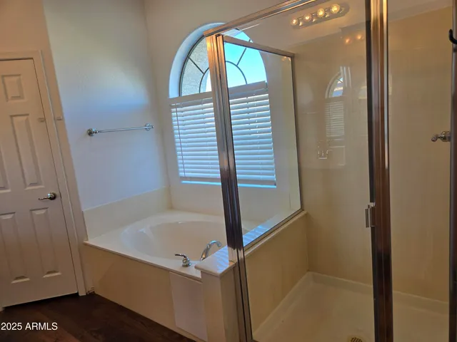a bathroom with a bathtub and a shower