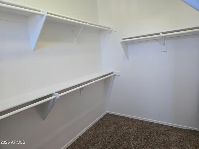 a view of empty room with ceiling fan