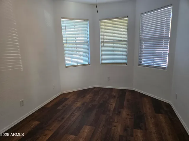 a view of a room with wooden floor and windows