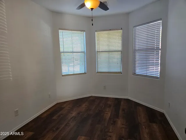 an empty room with wooden floor and closet