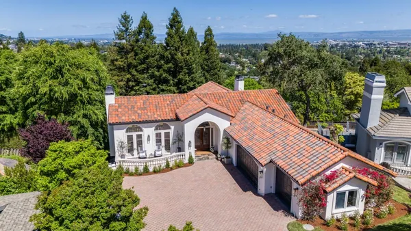 a aerial view of a house with a yard and balcony