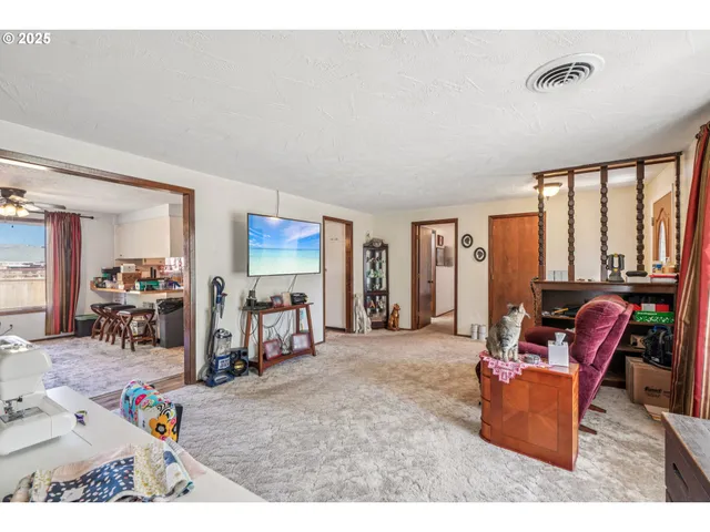 a living room with furniture a large window and a flat screen tv