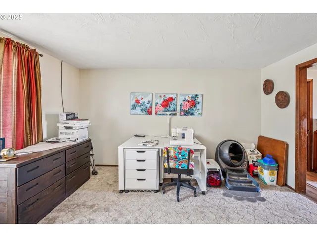 a bedroom with a bed a table and a closet