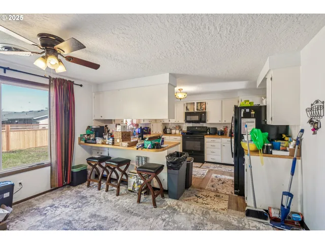 a view of a dining room with furniture and a window