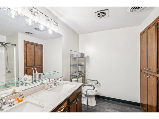 a bathroom with a sink a toilet and mirror